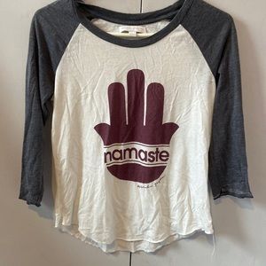 Spiritual Gangster raglan tee with “Namaste” in a hamsa.